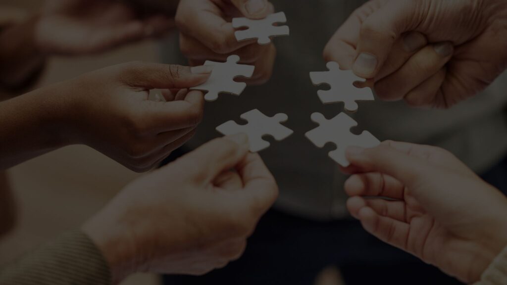 A photo with the text title “Rainmaker Consulting: Building an Internationalization Workforce for Established Businesses” and a background of hands holding puzzle pieces.