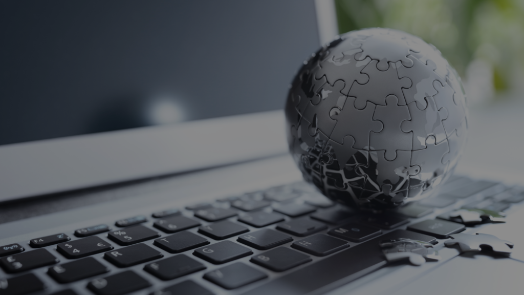 A metallic globe puzzle resting on a laptop keyboard, symbolizing the intricacies of mastering internationalization strategies. This image reflects global connectivity, strategic problem-solving, and the integration of technology in navigating international markets.